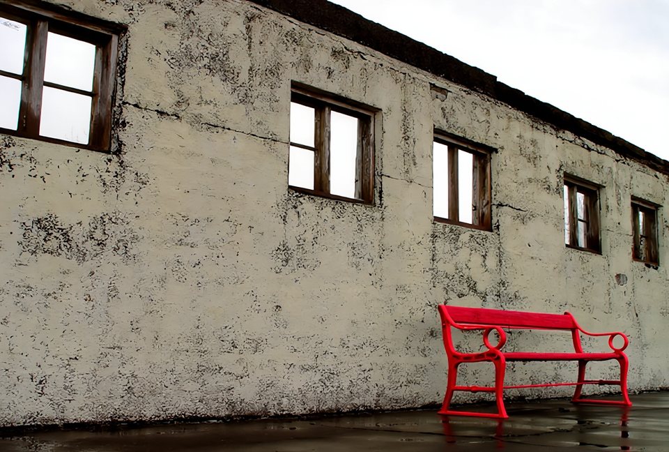 A concrete wall with a bright red bench after ten rounds of AutoPolish